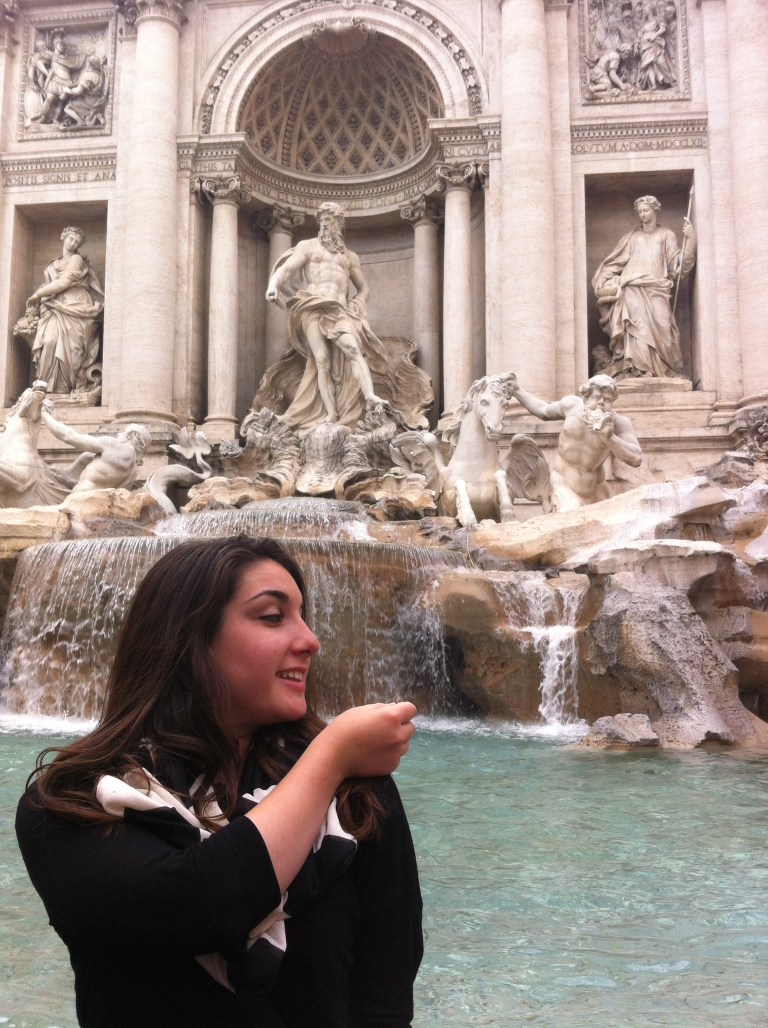 Making a wish with a coin into the Trevi Fountain