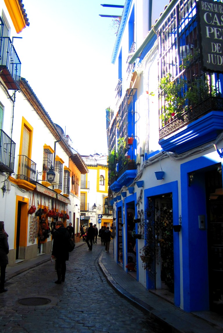 White washed and paint splattered side street in Córdoba, Spain.